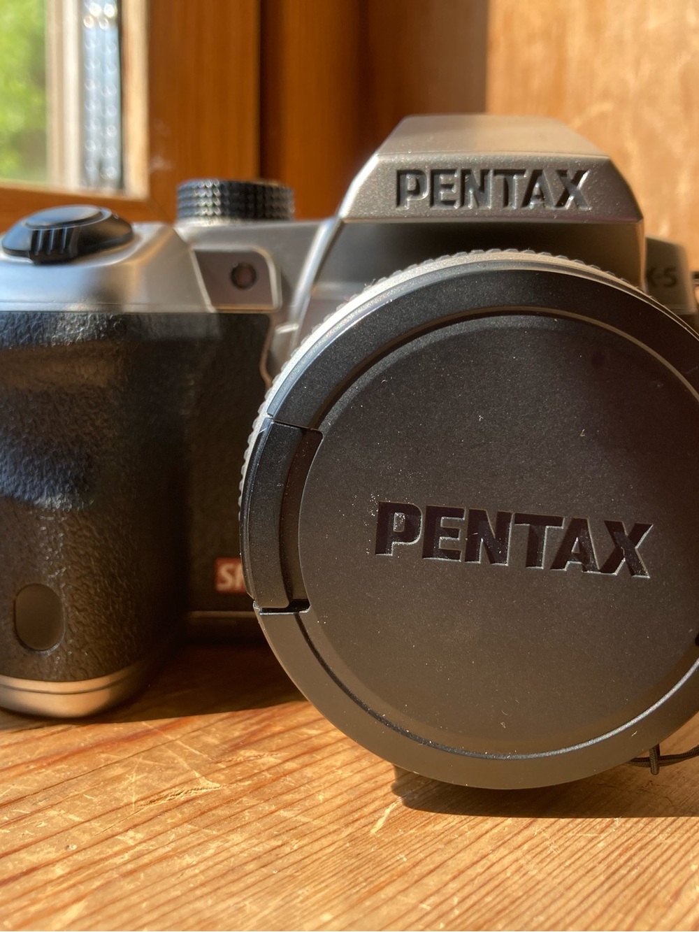 Pentax Black and Silver SLR Camera Body with Pentax Lens Cap